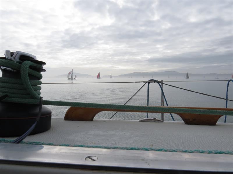 Limp kites struggle to lift as the fleet leaders drift down the East Bay flats. They pass the boats sailing upwind, coming the “wrong way” from Treasure Island - 2020 Three Bridge Fiasco photo copyright Susan Burden taken at Golden Gate Yacht Club and featuring the IRC class