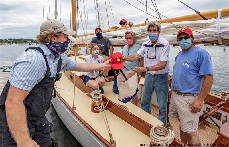 Former Secretary of State and U.S. Senator (Mass.) John Kerry receives his welcome bag from Chairman Alex Nugent before Edgartown Yacht Club's ‘Round-the-Island Race. Kerry and team went on to win their class and the coveted Venona Trophy photo copyright Stephen Cloutier taken at Edgartown Yacht Club and featuring the IRC class