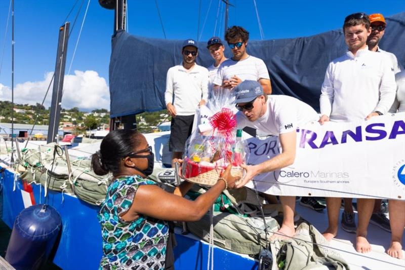 Receiving a beautiful basket of Grenadian fine produce (and rum!) from Grenada Tourism Authority on arrival photo copyright Arthur Daniel / RORC taken at Royal Ocean Racing Club and featuring the IRC class