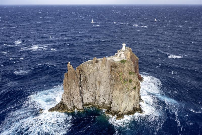 The Rolex Middle Sea Race fleet negotiate the passage close to Strombolicchio lighthouse - photo © Kurt Arrigo