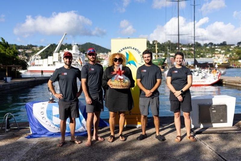 Petra Roach, CEO of Grenada Tourism Authority congratulates and presents Canada Ocean Racing with a gift basket photo copyright Arthur Daniel / RORC taken at Royal Ocean Racing Club and featuring the IRC class