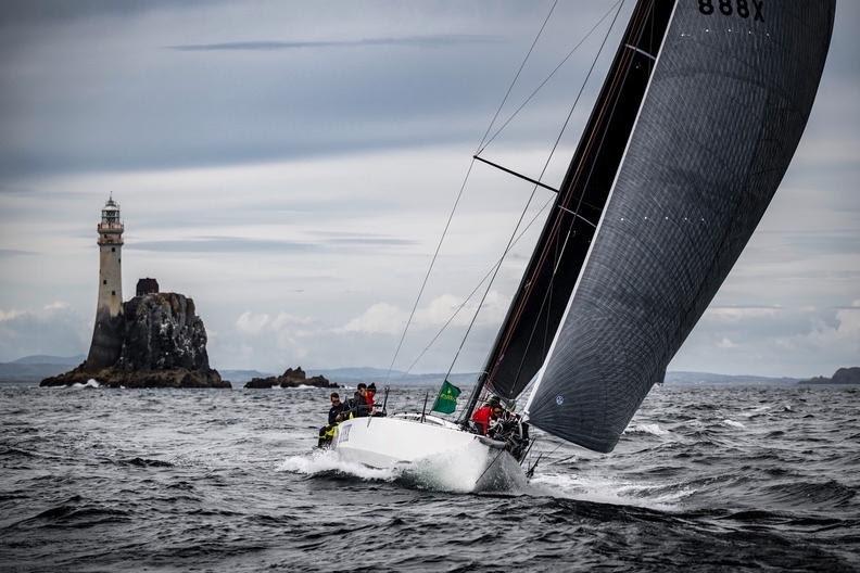 Thomas Kneen's JPK 1180 Sunrise III rounding the Fastnet Rock during the Rolex Fastnet Race photo copyright Rolex / Kurt Arrigo taken at Royal Ocean Racing Club and featuring the IRC class