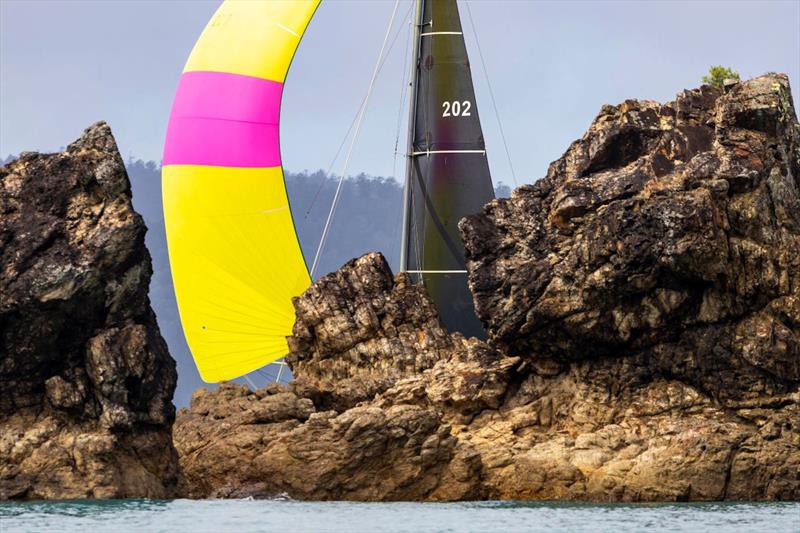 Reignition adds her own colour to the scenery - 74 Islands Distillery Airlie Beach Race Week photo copyright Andrea Francolini / ABRW taken at Whitsunday Sailing Club and featuring the IRC class