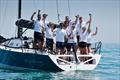 © Paul Wyeth / www.pwpictures.com Impetuous team celebrate, GBR 7737, on Monday at the International Paint Poole Regatta 2026 © Paul Wyeth / www.pwpictures.com