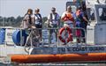 Chairman Anselm Richards (orange life vest) - Scenes from the 2026 Ida Lewis Distance Race