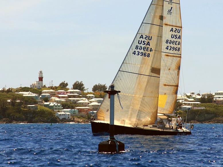 Alibi, a J120 sailed double-handed in the Marion Bermuda Race, finishes off St David's Lighthouse photo copyright SpectrumPhoto / Fran Grenon taken at Royal Hamilton Amateur Dinghy Club and featuring the J120 class
