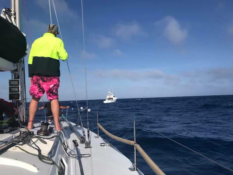 Patriot now under tow by NSW Water Police. Greg Coutss trying to bring some cheer to the devastated crew by brightening things up with pink shorts photo copyright Chris Furey taken at Cruising Yacht Club of Australia and featuring the J133 class