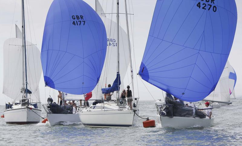 J/24's racing through the moorings during the Taittinger Royal Solent Regatta - photo © Jake Sugden / www.jakesugden.photoshelter.com