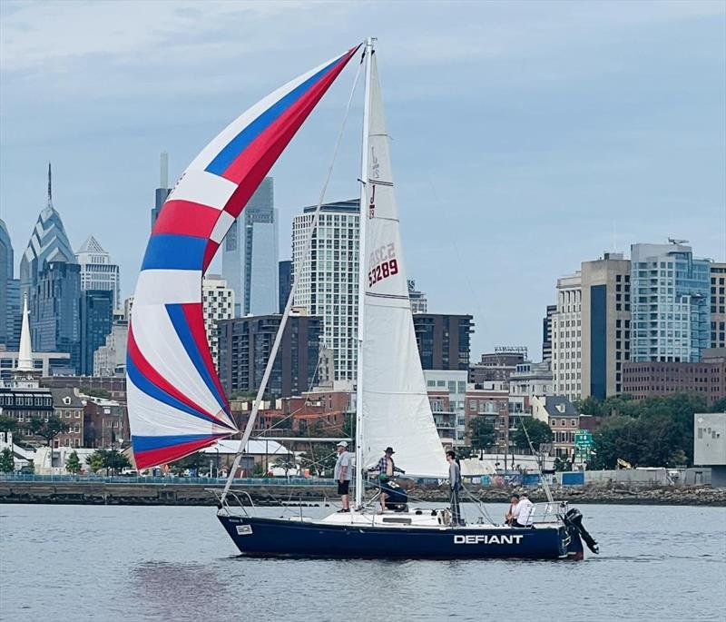 Riverton Yacht Club's Jon Burnham's Defiant crosses the finish line for a win - photo © Irina Bernatsky