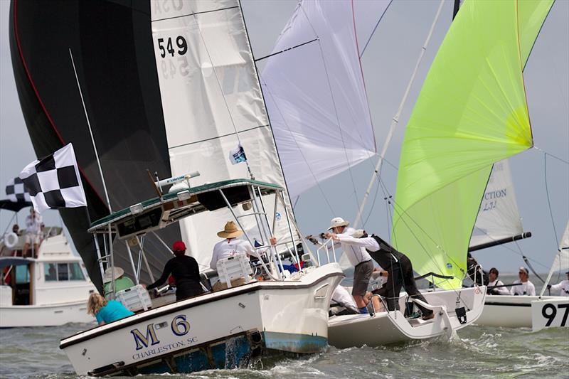 A J/70 and its crew get tangled up with the anchor line of a race committee boat at Sperry Charleston Race Week 2017 photo copyright Charleston Race Week / Meredith Block taken at Charleston Yacht Club and featuring the J70 class