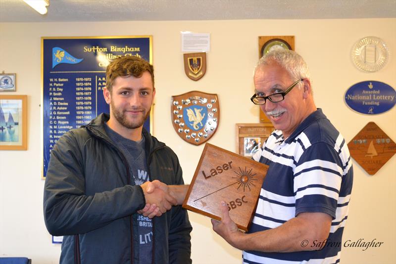 Rob Dyer presented with the Laser Standard trophy by Commodore, Phil Bailey photo copyright Saffron Gallagher taken at Sutton Bingham Sailing Club and featuring the ILCA 7 class