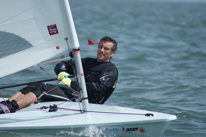 Daragh Kelleher (Skerries SC) crossing the line to take first blood in Race 1 of the Lennon Irish Laser Masters photo copyright Heather King taken at Royal St George Yacht Club and featuring the ILCA 7 class