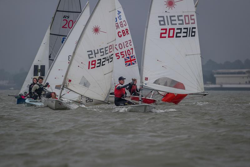 Harry Newton (202316) leads the way out of the first mark melee, Lee Windridge (193245) leads the chase during the KSSA Mid-Summer Regatta at Medway photo copyright Jon Bentman taken at Medway Yacht Club and featuring the ILCA 7 class