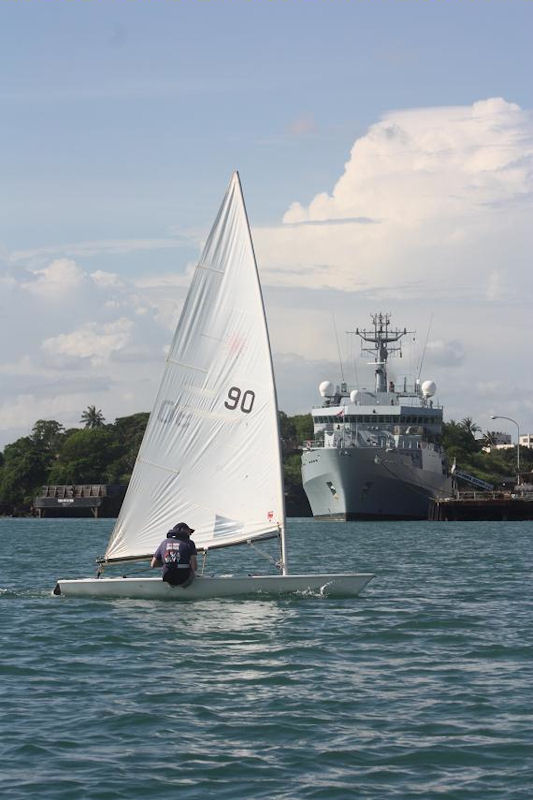 Lieutenant Richard Watsham sailing past HMS Echo alongside in Mombasa photo copyright Royal Navy taken at Mombasa Yacht Club and featuring the ILCA 7 class