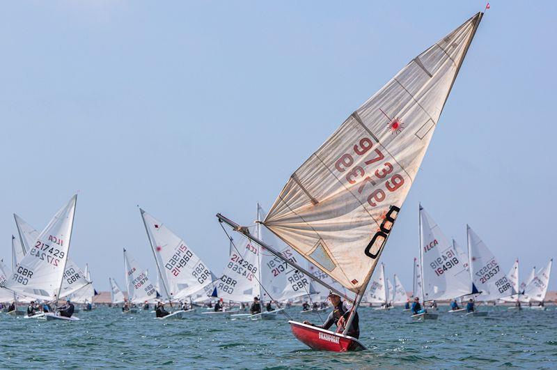 50 year old boat (with wooden foils and original sail) leads the fleet out to start line for UKLA UK National Championships photo copyright Georgie Altham / www.facebook.com/galthamphotography taken at Weymouth & Portland Sailing Academy and featuring the ILCA 7 class