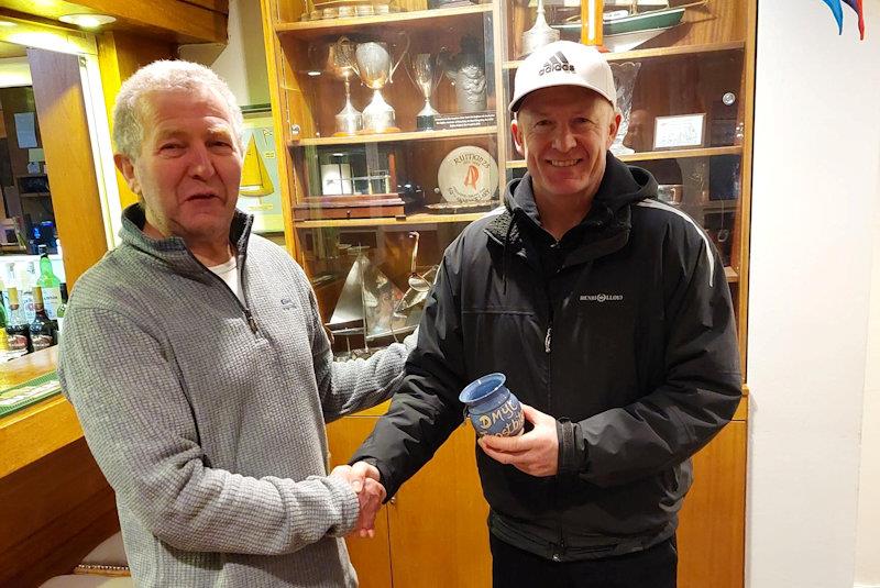 John O'Driscoll collects his Frostbite Mug for the day's racing from Neil Colin - Viking Marine Frostbite Series 1 at Dun Laoghaire photo copyright Cormac Bradley taken at Dun Laoghaire Motor Yacht Club and featuring the ILCA 7 class