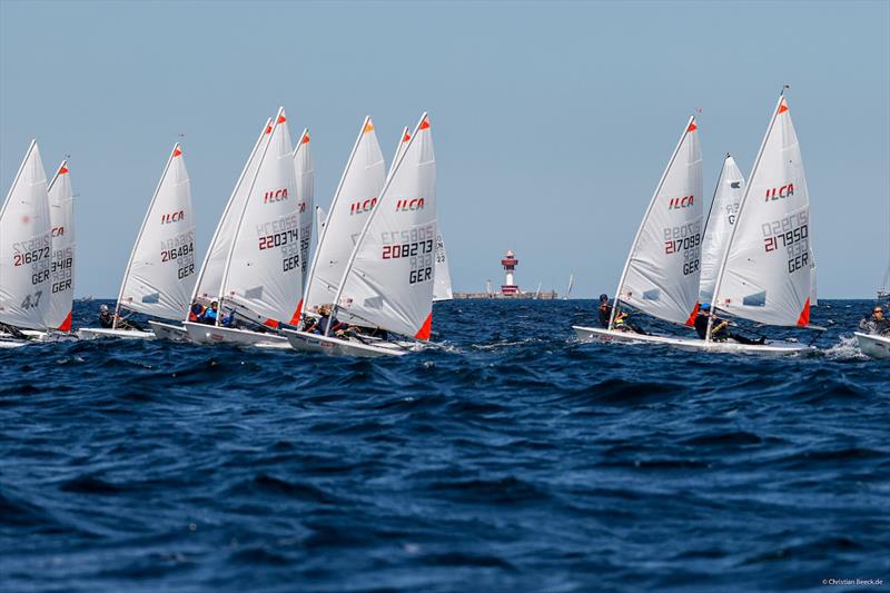 Norgwegians dominate the ILCA 4 fleet on race course Juliett with Kiel lighthouse in the background on day 1 of the Kiel Week Regatta photo copyright ChristianBeeck.de / Kieler Woche  taken at Kieler Yacht Club and featuring the ILCA 4 class