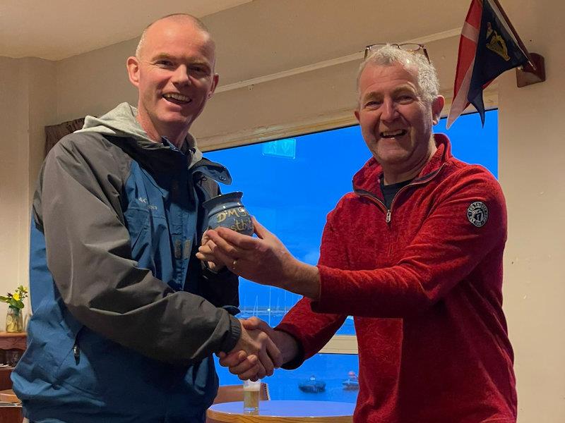 Conor Clancy (L) picks up a Frostbite Mug for Race 1 in the ILCA 6 fleet from Neil Colin photo copyright Sarah Dwyer taken at Dun Laoghaire Motor Yacht Club and featuring the ILCA 6 class