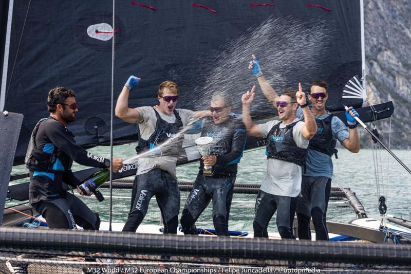 Bliksem with skipper Pieter Taselaar spraying the prosecco in Riva - M32 European Championships 2022 photo copyright M32World / Felipe Juncadella taken at Fraglia Vela Riva and featuring the M32 class