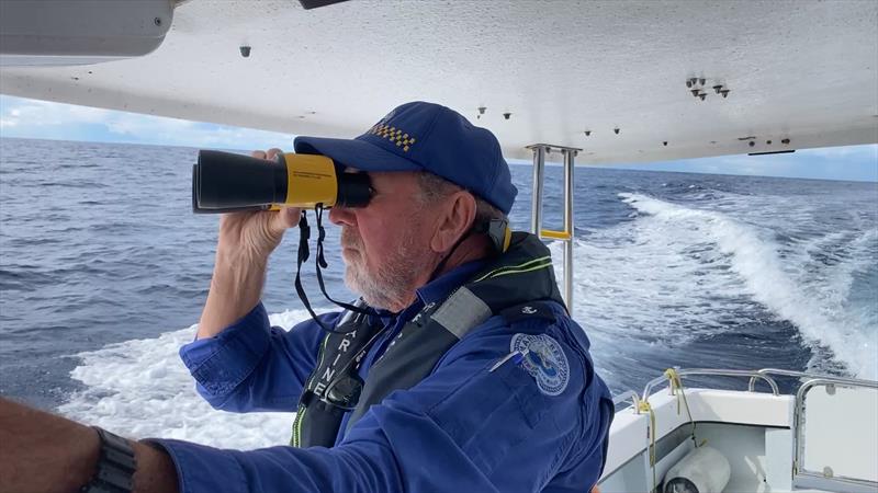 A Marine Rescue Shoalhaven volunteer searches waters off Port Kembla - photo © Marine Rescue NSW
