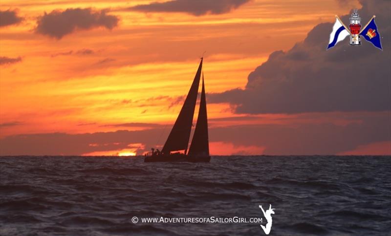 A competitor approaches the finish line as dawn breaks on Wednesday off St. David's Lighthouse in Bermuda photo copyright Nic Douglass / www.AdventuresofaSailorGirl.com taken at Royal Bermuda Yacht Club and featuring the Maxi class