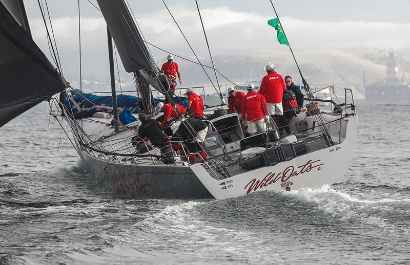 Wild Oats XI passes the oil rig parked in the Derwent River photo copyright Crosbie Lorimer taken at Cruising Yacht Club of Australia and featuring the Maxi class