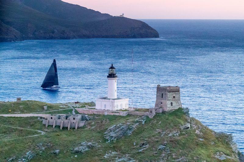 Sir Lindsay Owen-Jones' WallyCento Magic Carpet 3 rounds the Giraglia Rock at dusk in the Rolex Giraglia Offshore Race - photo © Carlo Borlenghi