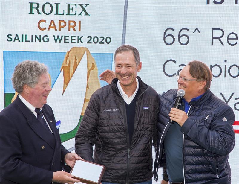 Alex Schaerer and Francesco de Angelis are presented with a 2019 Rolex Capri Sailing Week trophy by IMA Secretary General Andrew McIrvine. - photo © Studio Borlenghi / International Maxi Association