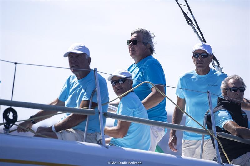 Alessandro Del Bono helming Capricorno with Flavio Favini to the right - Maxi Yacht Rolex Cup photo copyright IMA / Studio Borlenghi taken at Yacht Club Costa Smeralda and featuring the Maxi class