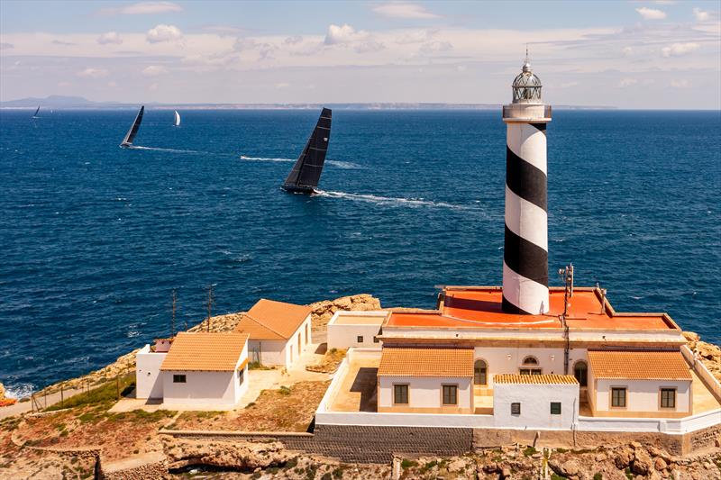 IRC/IMA Maxi fleet & lighthouse of Cala Figuera on day 1 of PalmaVela 2022 photo copyright Jacobo Bastos / PalmaVela taken at Real Club Náutico de Palma and featuring the Maxi class