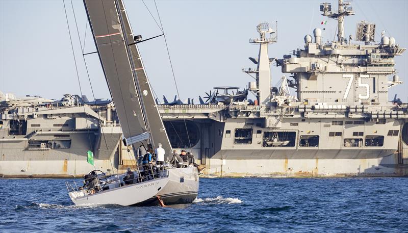 Gregor Stimpfl's Hägar V with the 332m long USS Harry S Truman. - 2022 IMA Maxi European Championship - photo © ROLEX / Studio Borlenghi