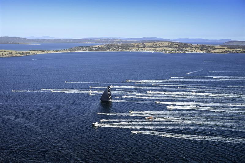 Spectator fleet brings Master Lock Comanche up the River Derwent photo copyright Rolex / Kurt Arrigo taken at Cruising Yacht Club of Australia and featuring the Maxi class
