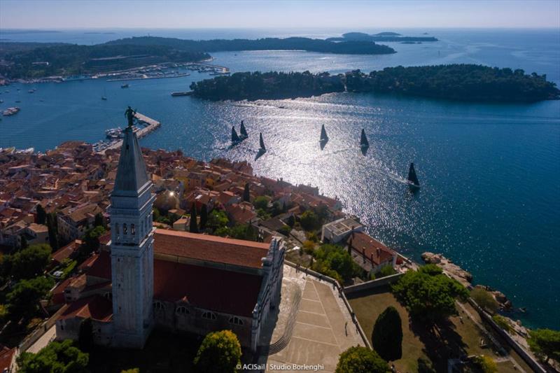 Ancient, densely spaced terracotta-roofed buildings and the giant baroque basilica of St Euphemia of Rovinj's old town are a perfect backdrop for tough and competitive racing. - photo © ACI Sail | Studio Borlenghi