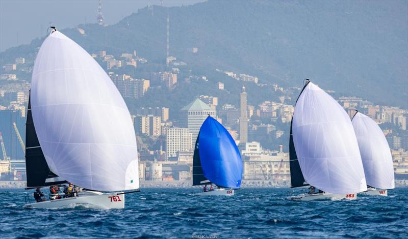 Melges 24 fleet sailing in front of La Lanterna at the Melges 24 European Championship 2022 in Genoa  - photo © IM24CA / Zerogradinord