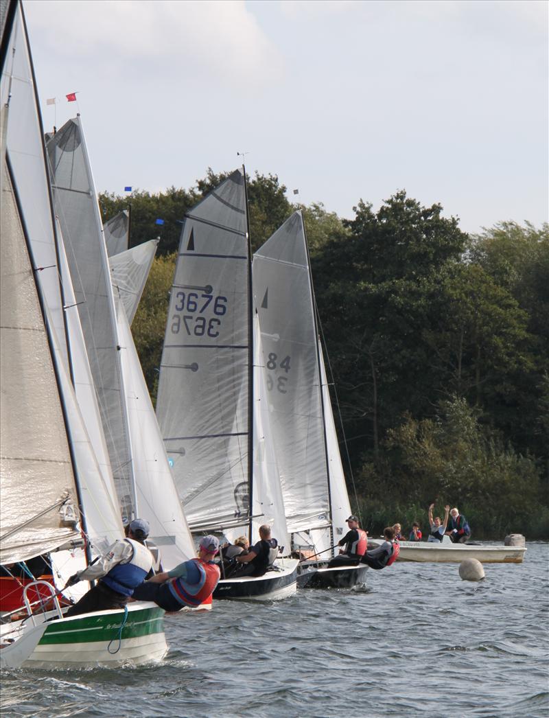 Merlin Rockets race beneath a view of Wembley Stadium photo copyright Liz Martin taken at Wembley Sailing Club and featuring the Merlin Rocket class