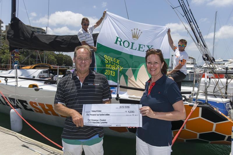 Russell McCart accepts the cheque from CYCA Associates President Pam Messenger photo copyright Andrea Francolini taken at Cruising Yacht Club of Australia