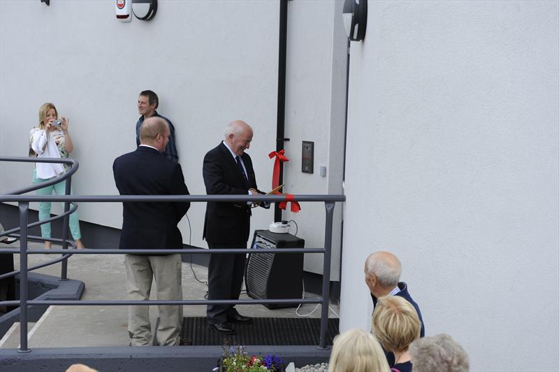 One of Carrickfergus Sailing Club’s longest serving members, Terry Windsor cuts the ribbon to officially open the newly restored clubhouse, just over two years after it was destroyed in a major fire photo copyright Nigel Thompson taken at Carrickfergus Sailing Club