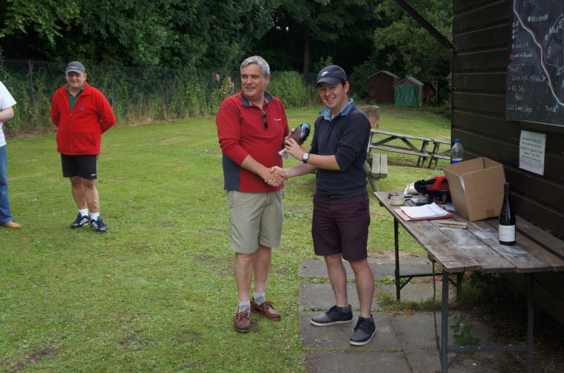 Club Captain Tom Harris presents the Colemere Sailing Club Grand Prix trophy to Nick Edmunds photo copyright Steve Murphy taken at Colemere Sailing Club