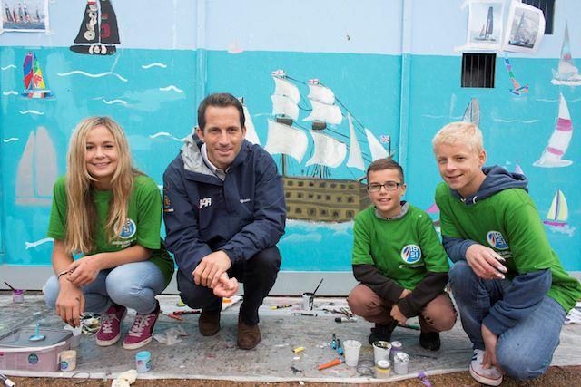 Admiral Lord Nelson School pupils and Sir Ben Ainslie pictured painting HMS Victory on the walls of the new Ben Ainslie Racing HQ today - photo © Mark Lloyd / www.lloydimages.com