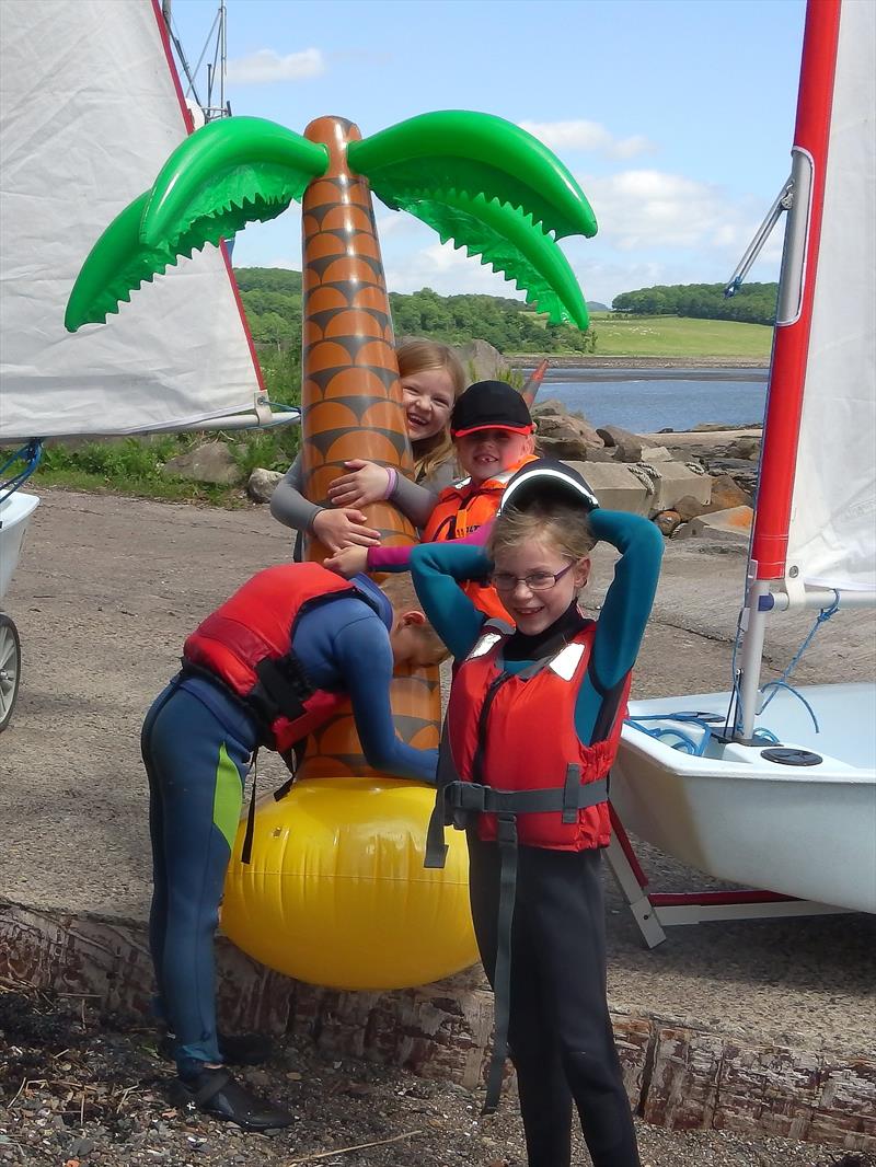 James, Leonie, Sophie and Chloe hug a palm tree to enjoy the tropical conditions during the Dalgety Bay Development Regatta photo copyright Kiki Papapanagioutou taken at Dalgety Bay Sailing Club