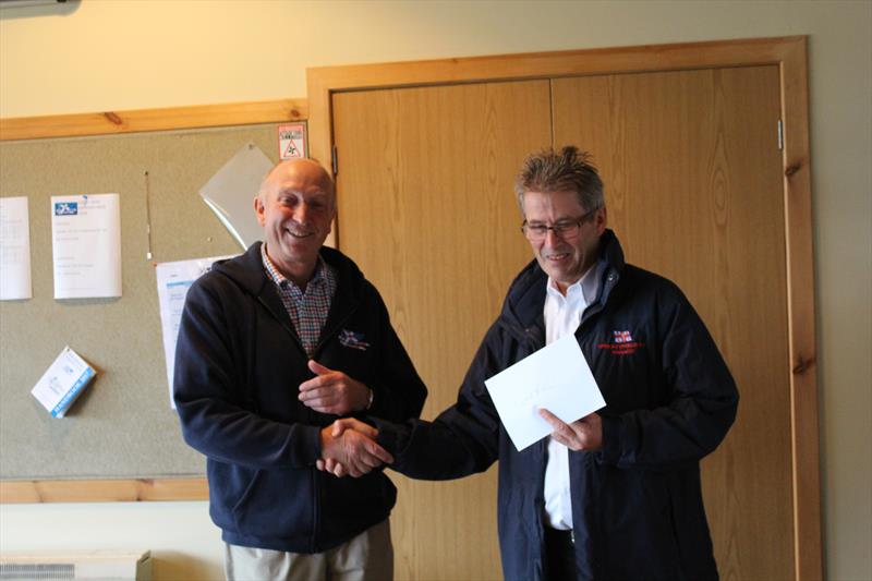 Solway Yacht Club Commodore, Ian Purkis, presenting the cheque for £1365 raised by the sailors in the RNLI Regatta Race to Gareth Jones, Kippford RNLI Operations Manager, at Solway YC Kippford Week photo copyright Beatrice Overend taken at Solway Yacht Club