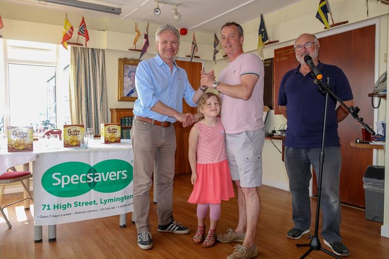 Ian Sanderson collecting his prize with daughter Lottie presented by Neil Constantine-Smith and hosted by Commodore Chris Caswell at the Keyhaven Yacht Club Easter Regatta photo copyright Nick Boxall taken at Keyhaven Yacht Club