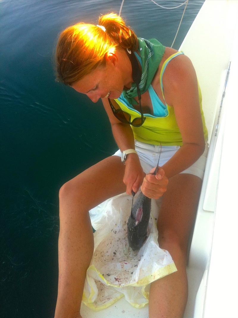 Sarah Baerschmidt prepares a tuna for supper on board Omnia kindly donated by a passing Omani fisherman photo copyright Omnia taken at 