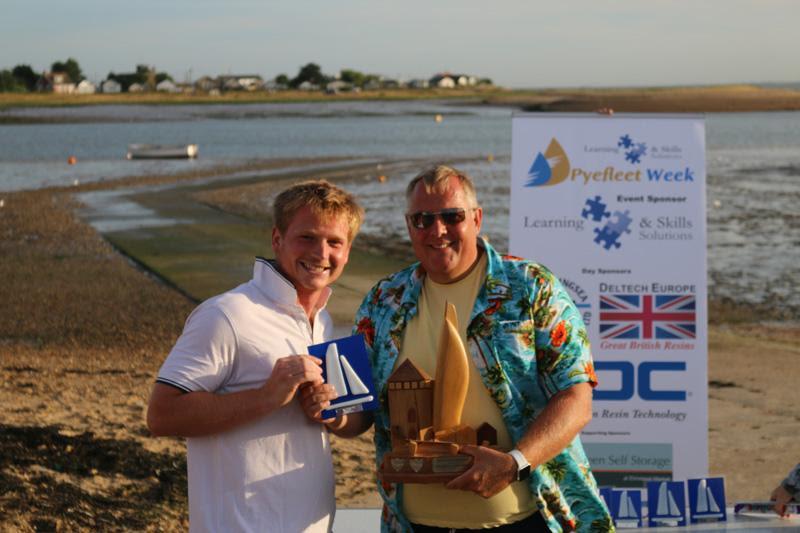 Mark White presents Ben Clegg (L) with the beautiful Pyefleet Week Big Wednesday Trophy at Learning & Skills Solutions Pyefleet Week photo copyright William Stacey taken at Brightlingsea Sailing Club