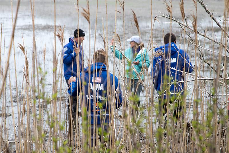 Sailors from Vestas 11th Hour Racing head into the marsh with Wenley Ferguson, Director of Habitat Restoration at Save The Bay to learn about restoration and help dig runnels so water can flow off the marsh photo copyright Harbor Beacon taken at 