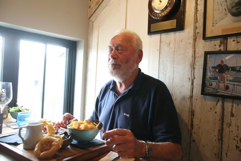 Golden moment... Sir Robin Knox-Johnston resampling his first meal of steak and chips served at the Chain Locker Pub Falmouth 50 years before, with the Guinness barometer mounted on the wall behind. - photo © Bill Rowntree / PPL / GGR