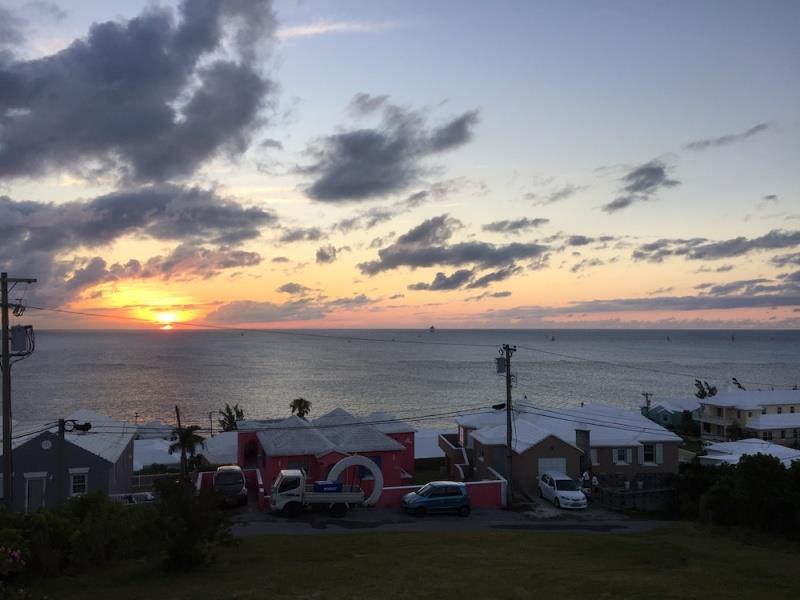 The view from the inshore end of the finish line at St. David's Lighthouse at dawn, on Wednesday. The finish line, with a series of boats approaching, is just to the right of the telephone pole photo copyright John Burnham taken at Royal Bermuda Yacht Club