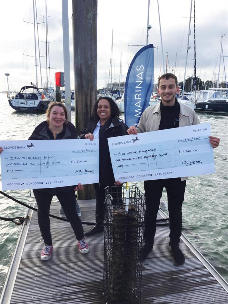 Maxine Lane, Senior Marketing Manager at MDL Marinas, presenting cheques to Jacob Kean Hammerson from Blue Marine Foundation and Peta Koczy (Staff Skipper) from Ocean Youth Trust (South) at Port Hamble Marina photo copyright MDL Marinas taken at 