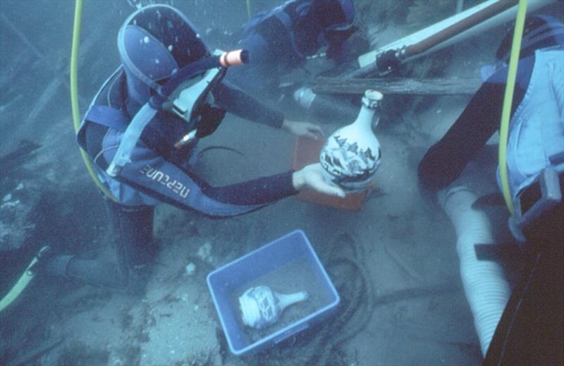 Diver recovering a porcelain flask - photo © Tas Parks