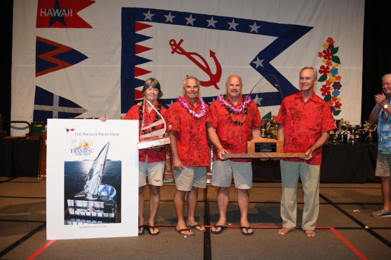 The crew of the Eddy family's Cal 40 Callisto accepting their awards in Division 10 - Transpac 50 photo copyright Walt Cooper / Ultimate Sailing taken at Transpacific Yacht Club